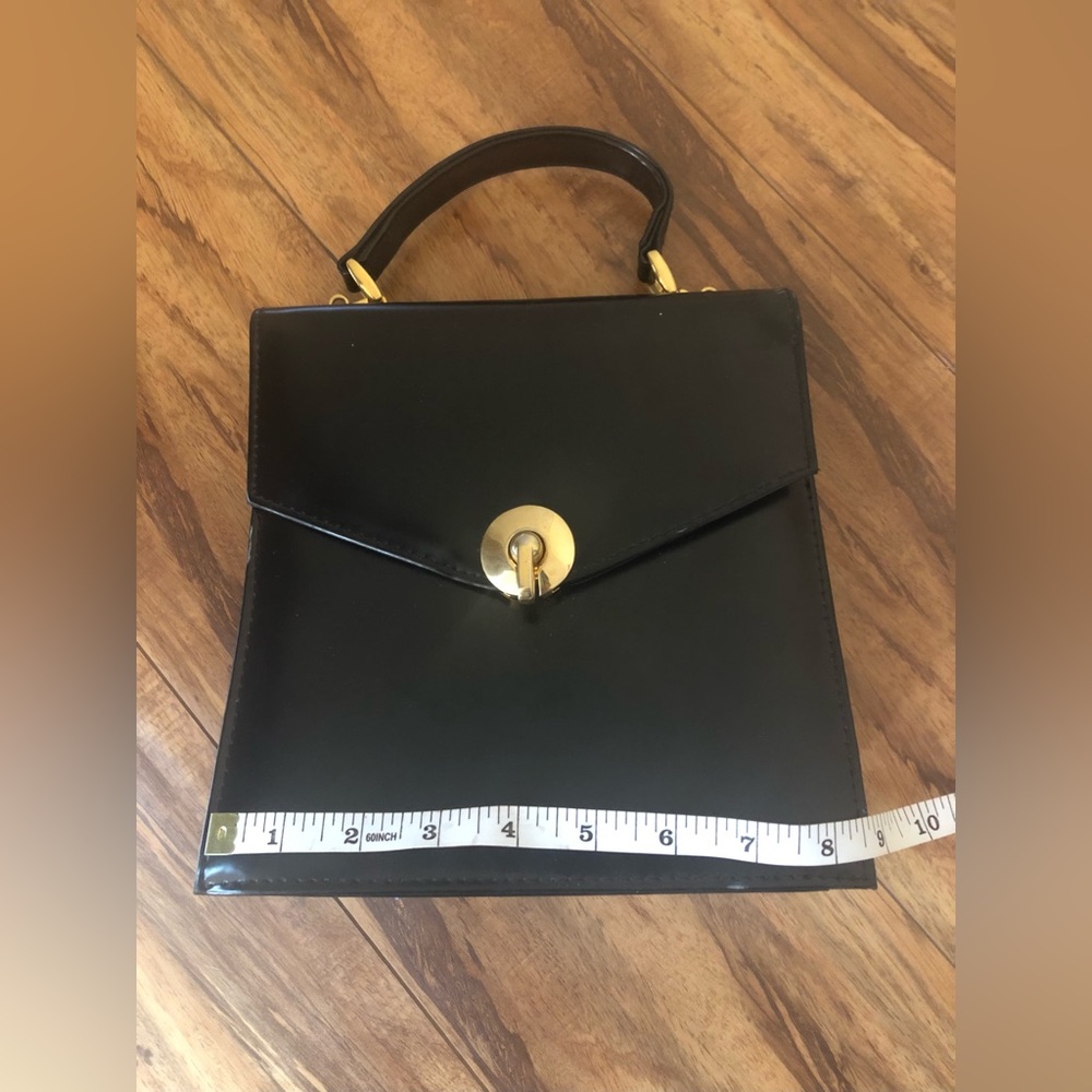 Super cute unbranded black vinyl with gold colored hardware bag